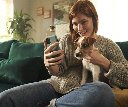 Woman with phone and dog